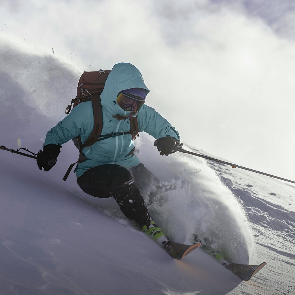 Person skiing in a Light blue Lightweight Prophet Pertex Rain Coat