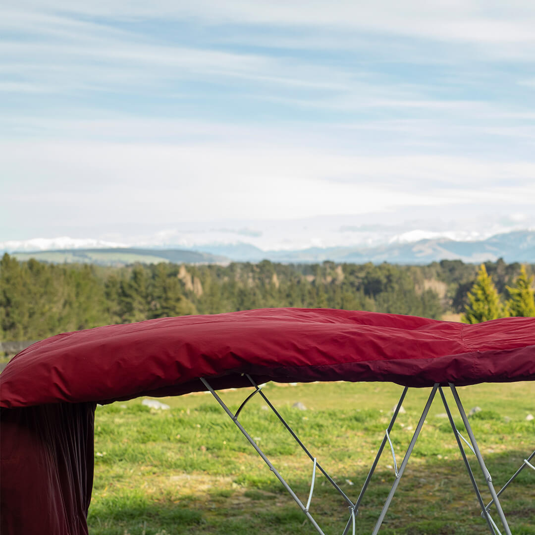Red Sleeping Bag hanging on clothes rack outside
