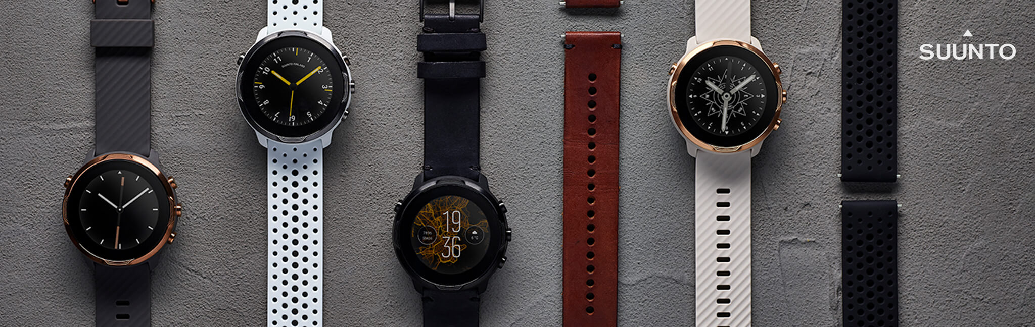 Suunto watches with straps multi colours on grey stone background